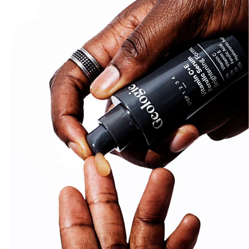 Dispensing Sun Protection Essentials sunscreen-infused liquid foundation from a Geologie bottle onto a fingertip.