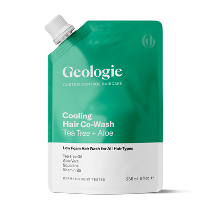 A standing green pouch of Geologie Co-Wash Cleansing Conditioner with Tea Tree + Aloe, 236 ml, lists ingredients: Tea Tree Oil, Aloe Vera, Squalane, Vitamin B5. This co-wash is labeled for all hair types and acts to clean and condition hair while promoting a healthier scalp.