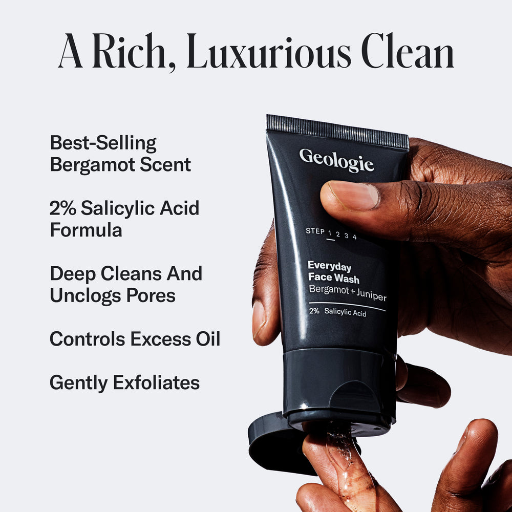 A hand holding a tube of Geologie Complete Skincare Set with text detailing its benefits, including 2% salicylic acid and oil control properties.