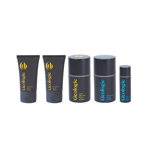 A package of five full-size skincare products with the brand name 'Geologie,' including tubes and jars designed for daily use, a morning cream, and a repairing serum.