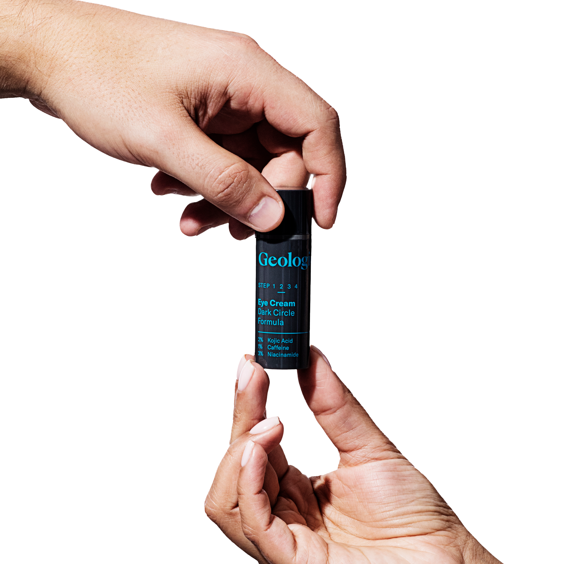 Two hands holding a tube of Geologie Dark Under Eye Duo against a black background.