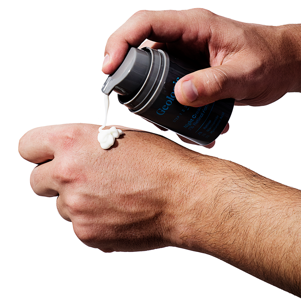 Applying a dollop of Geologie's Acne Duo cream from a container, boasting effective ingredients, to the back of a hand.