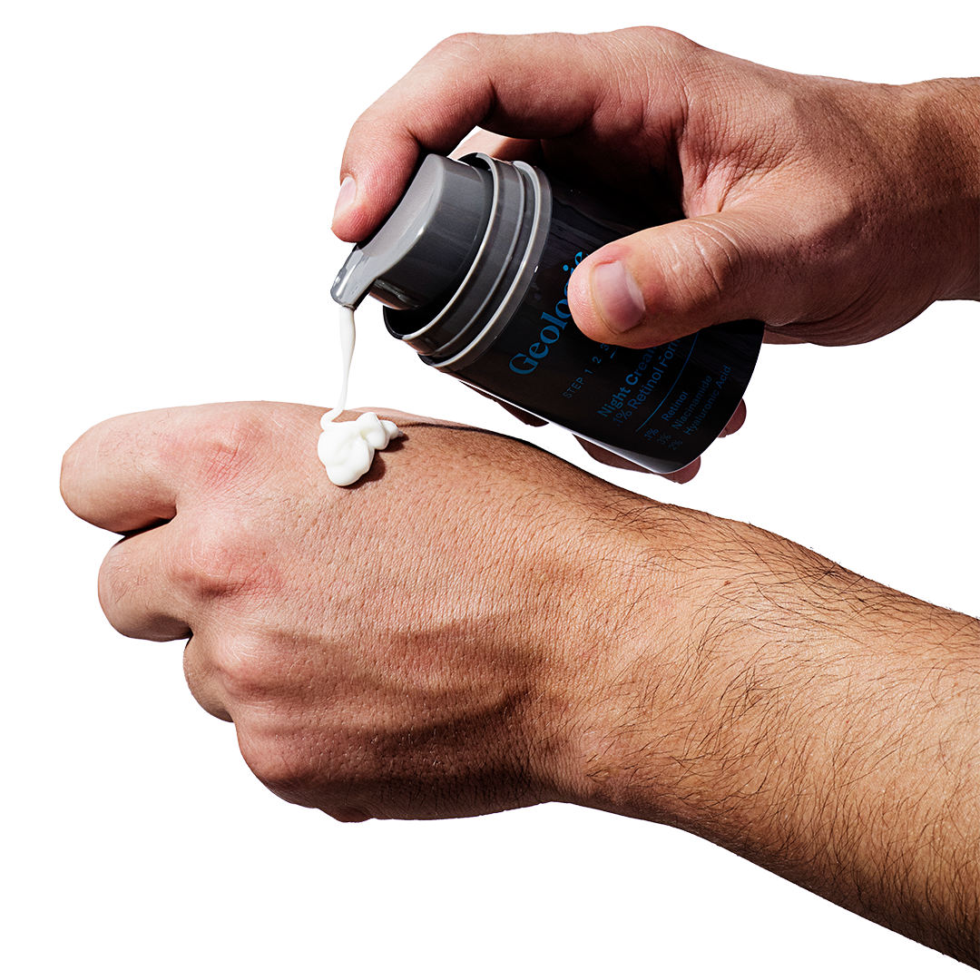 Applying Geologie's Anti Aging Duo cream from a container to the back of a hand.