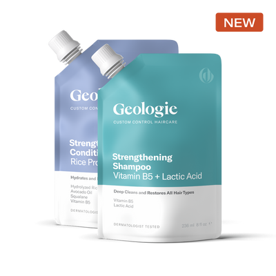 Two bottles of Geologie Shampoo + Conditioner, featuring a custom conditioner that nourishes and a strengthening shampoo that repairs, labeled as containing vitamin B5 and lactic acid, dermatologist tested, with a